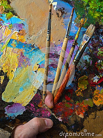 Painter holding a palette for mixing oil paints Stock Photo