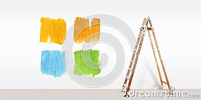 Painter ladder with paint colors samples, isolated on wall Stock Photo