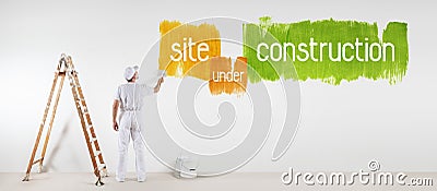 Painter man with paint brush drawing under construction text Stock Photo