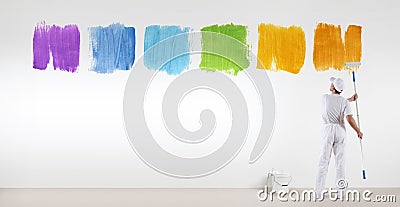 Painter man painting varied colors symbol isolated on wall Stock Photo