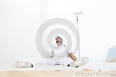 Painter man tired, lying on the floor Stock Photo