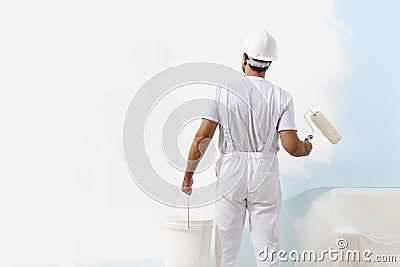 Painter man at work with a paint roller and bucket Stock Photo