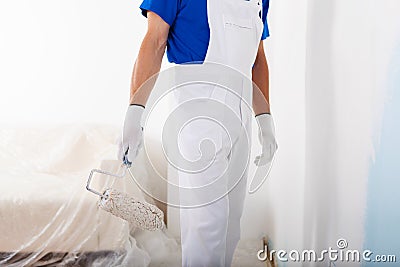 Painter with paint roller Stock Photo