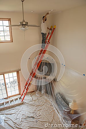 Painter painting a home Editorial Stock Photo