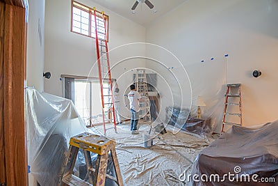 Painter painting a house Editorial Stock Photo