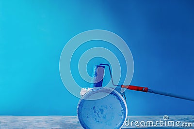 The painter paints the wall with a fur roller, a backdrop, a background Stock Photo