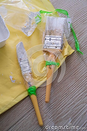 Painter's brush wrapped in plastic to prevent from drying up. Reusable for next project Stock Photo