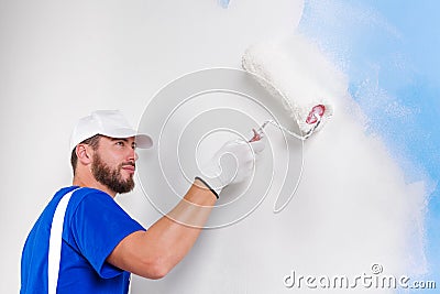 Painter in white dungarees, blue t-shirt Stock Photo