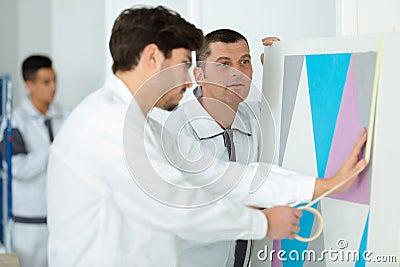 Painter worker protecting with masking tape Stock Photo