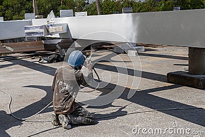 The painter is working to fireproof paint on steel structure with spray gun Stock Photo