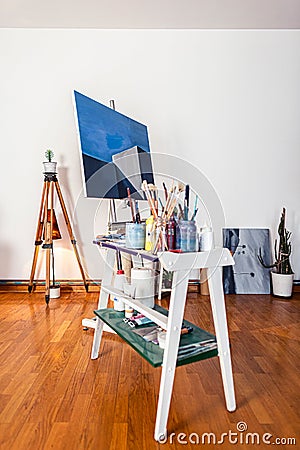A painters home studio with art work and brushes Stock Photo