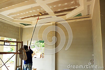 Painters are painting the ceiling of a new home Stock Photo