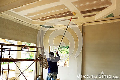 Painters are painting the ceiling of a new home Stock Photo