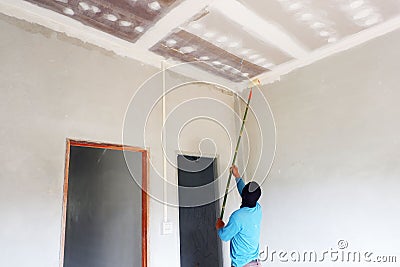 Painters are painting the ceiling of a new home Stock Photo