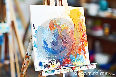 a painting easel with fresh paint and brushes Stock Photo