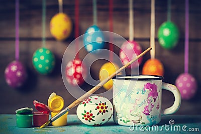 Painting Easter eggs and hanging colorful eggs on background Stock Photo