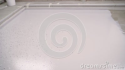 Grey Epoxy flooring textured background. Painting the floor in an industrial building in white. Stock Photo