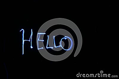 Painting HELLO in thin air with light with time laps aka bulb exposure Stock Photo