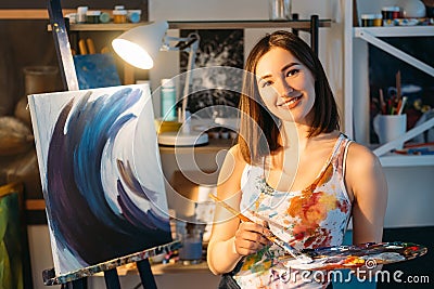 painting hobby happy female artist in workshop Stock Photo