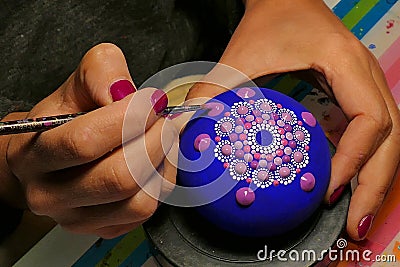 Painting of a stone with the Mandala technique Cartoon Illustration