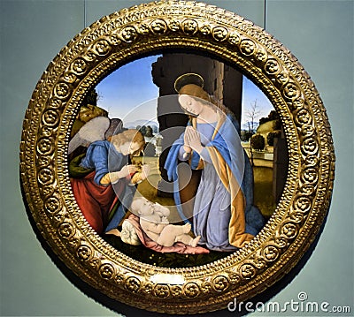 Painting in the shape of a circle, in which the Madonno who adores the baby Jesus is represented, at the Uffizi museum in Florence Editorial Stock Photo