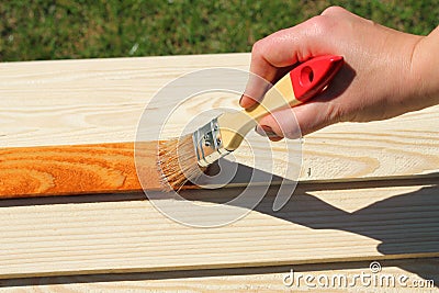 Painting wooden furniture piece Stock Photo