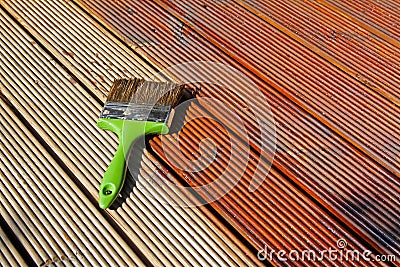 Painting wooden patio deck with protective oil Stock Photo