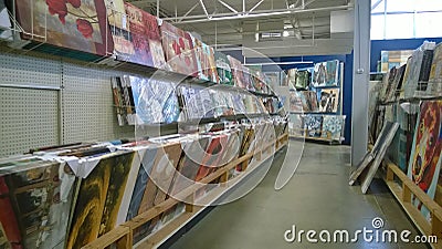 Paintings on shelves selling at store Editorial Stock Photo