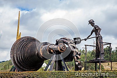 Beautiful industrial art sculpture by Jose Medardo Leguizamo of a man using coal to generate Editorial Stock Photo