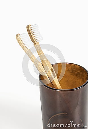 A pair of bamboo toothbrushes on a light background Stock Photo