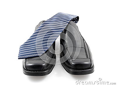 Pair of black male business shoes and blue tie Stock Photo