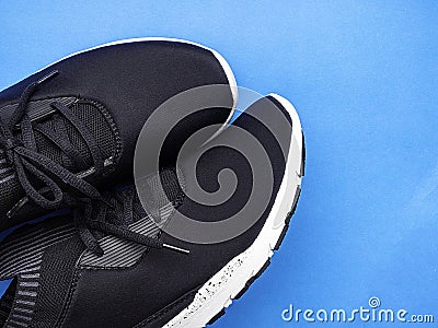 Black sport shoes on blue background Stock Photo