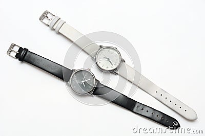 A pair of black and white color contrasting yet similar design wrist watches Stock Photo