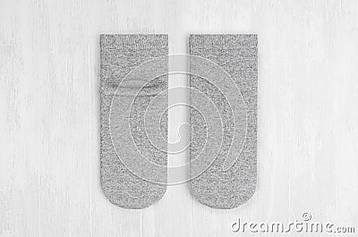 Pair blank grey medium socks flat lay on white wood board, front view, backside- mock up for design, print, presentation. Stock Photo