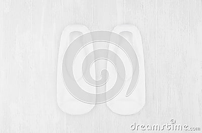 Pair blank white small, low socks flat lay on white wood board, front view - mock up for design, print, presentation, advertising. Stock Photo