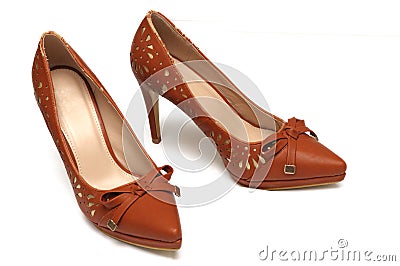 A pair of brown colored ladies high heels shoes with a bow ribbon at the front Stock Photo