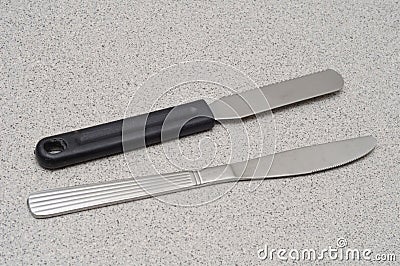 A pair of butter bread spread knives one with black plastic handle Stock Photo