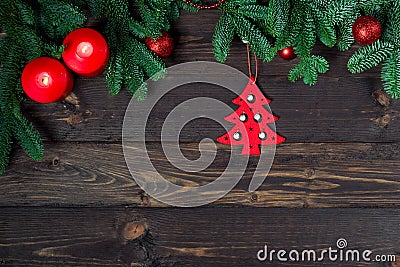 a pair of candles and fir branches on wooden boards, space for congratulations Stock Photo