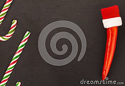 Pair of candy cane chili pepper sharp red cap copy space base black background Stock Photo