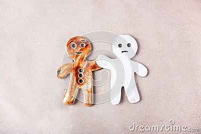 A pair of ceramic figurines of people lies on a paper Stock Photo