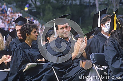 A pair of coeds watching their ceremony Editorial Stock Photo