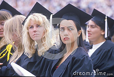 A pair of coeds watching their ceremony, Editorial Stock Photo