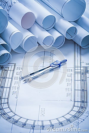 Pair of compasses with blueprints building and Stock Photo