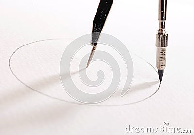 Pair of compasses drawing circle Stock Photo