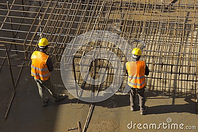 Construction workers attaching rebar Stock Photo