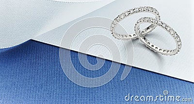 Diamond Eternity Rings on Blue and White Background Stock Photo