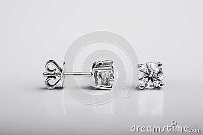 Pair of Diamond and white gold stud earrings on white background Stock Photo