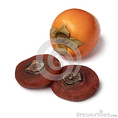 Pair of dried kaki persimmon and a fresh one on white background close up Stock Photo