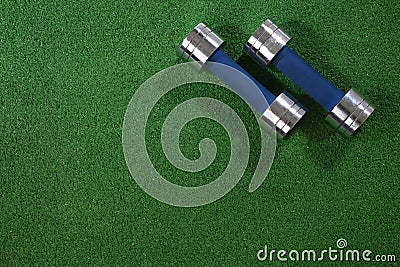 A pair of dumbells on a grass background Stock Photo
