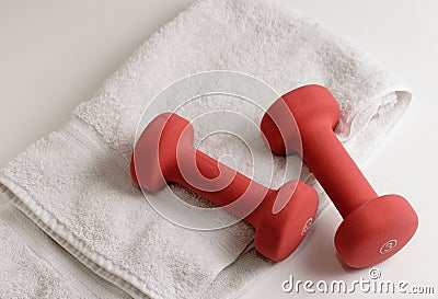 A pair of dumbells and white towel Stock Photo